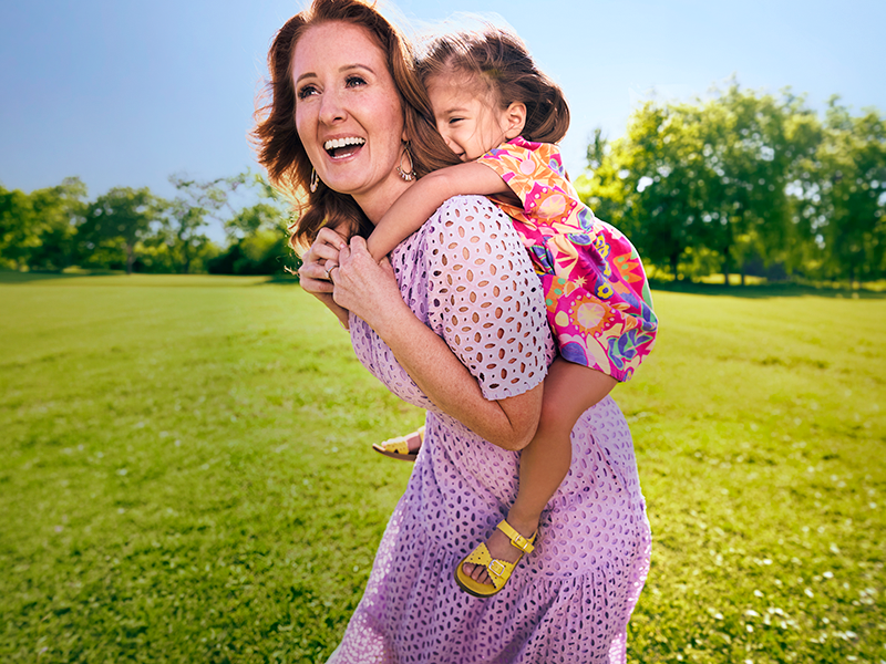 Woman with daughter on shoulders
