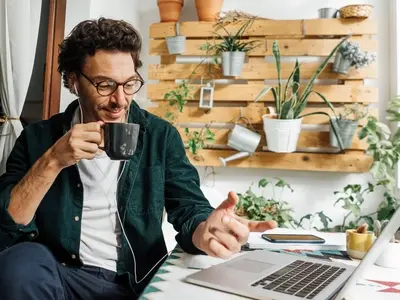 A man sits at his laptop wondering how to manage stress at work