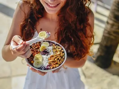 A woman eating a healthy meal to get rid of bloating fast.