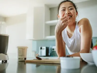 A woman eating healthy foods on a diverticulitis diet