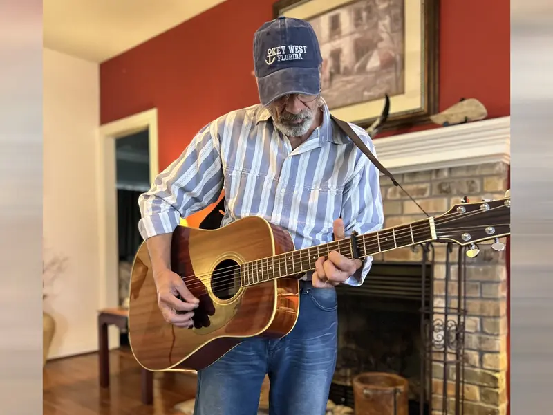 Larry Gambone playing guitar