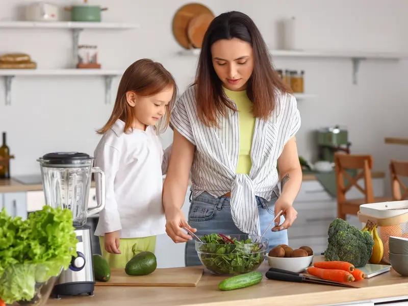 Mom and daughter making dinner.