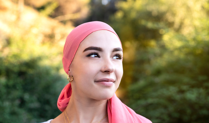 Female cancer survivor looking off into the distance.