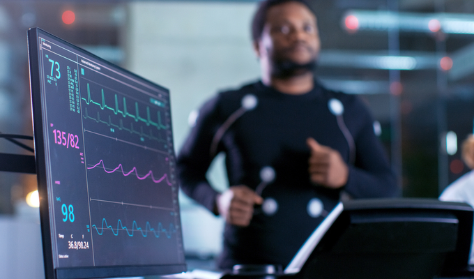 A man runs on a treadmill while collecting heart medical data
