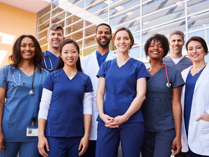 Doctors and nurses posing together for a professional team photo