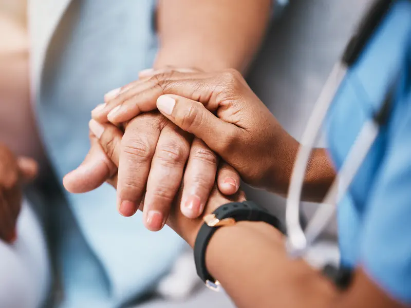 patient suffering from osteomyelitis receiving comfort from a nurse
