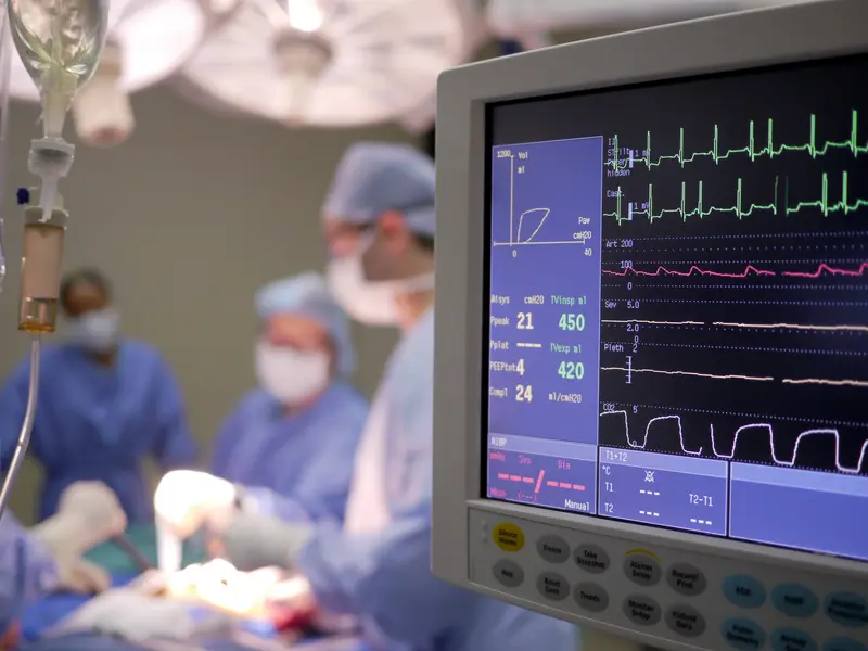 Close-up of monitoring device displaying vitals of a patient undergoing heart and vascular surgery in the operating room