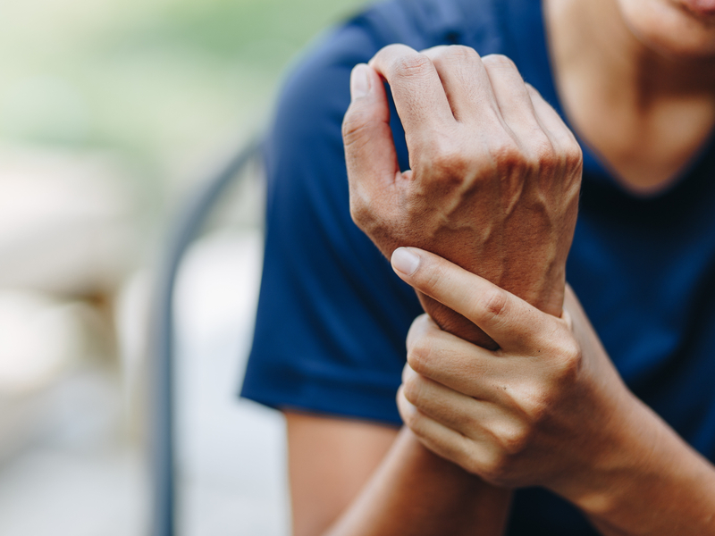 patient grasping their wrist from arthritis pain