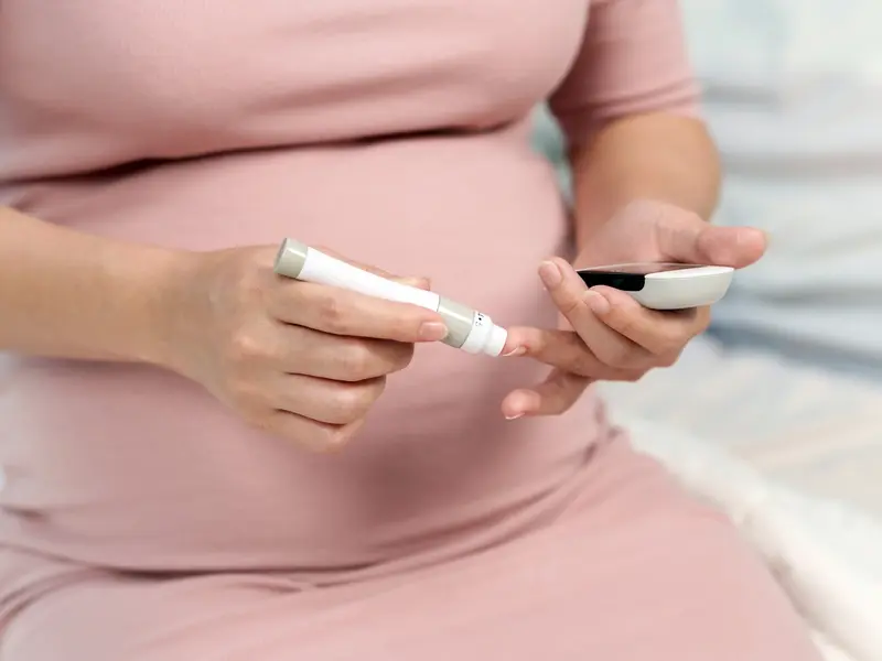 Woman checking her blood sugar levels. 