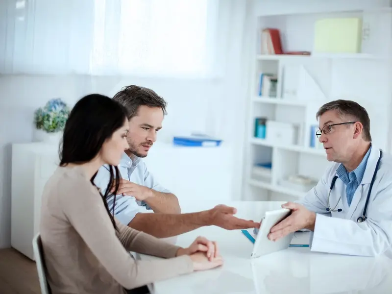 Doctor discussing Intracytoplasmic Sperm Injection ICSI with a couple