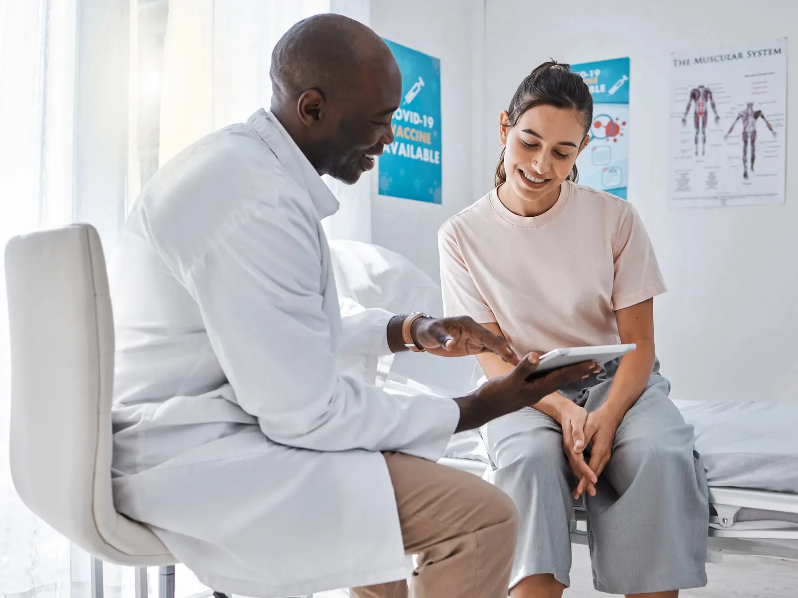 A doctor speaks with a patient about her dexa scan results.