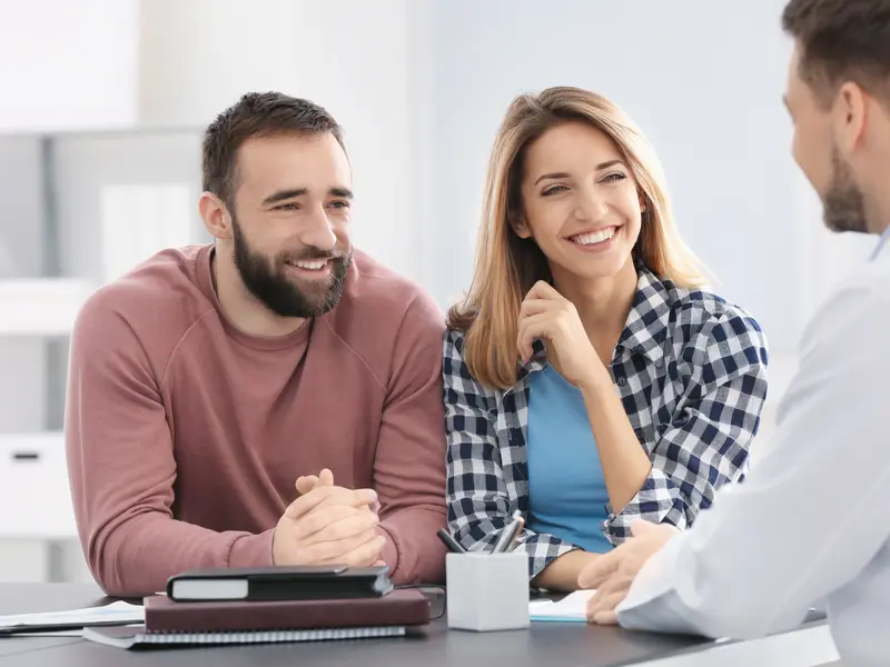 happy couple at an appointment seeking fertility treatment