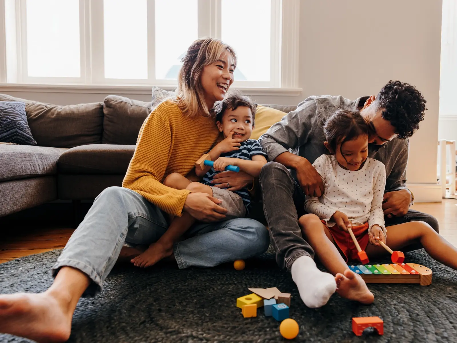 Two parents playing with kids who have  had the MMR vaccine during the measles outbreak.