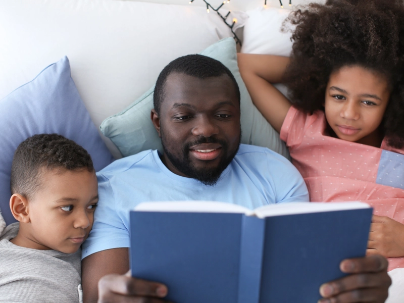 Father reading to his kids after going through immunotherapy