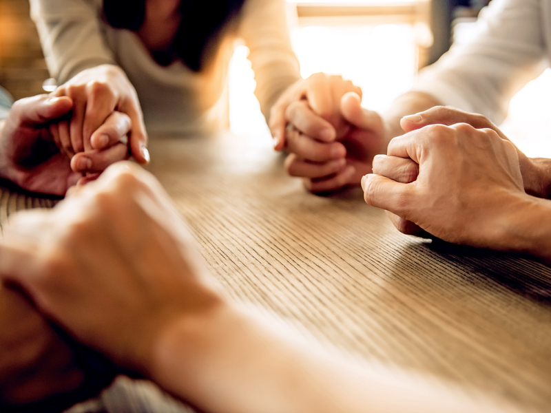 A group of parents gather in a support circle after experiencing pregnancy loss