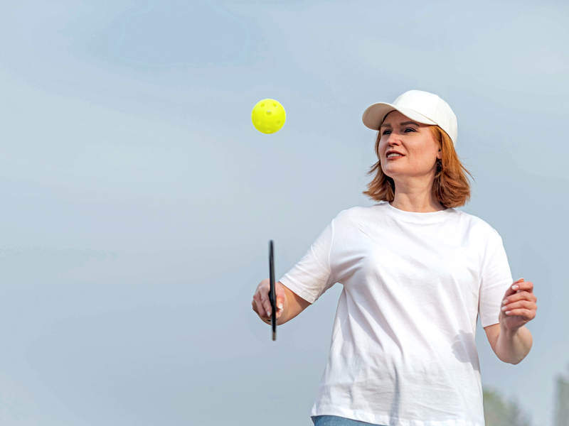 Woman playing pickleball after recovering from treatment for tendonitis