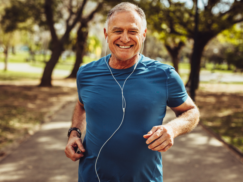 older male patient enjoying a run outside after receiving treatment for musculoskeletal pain