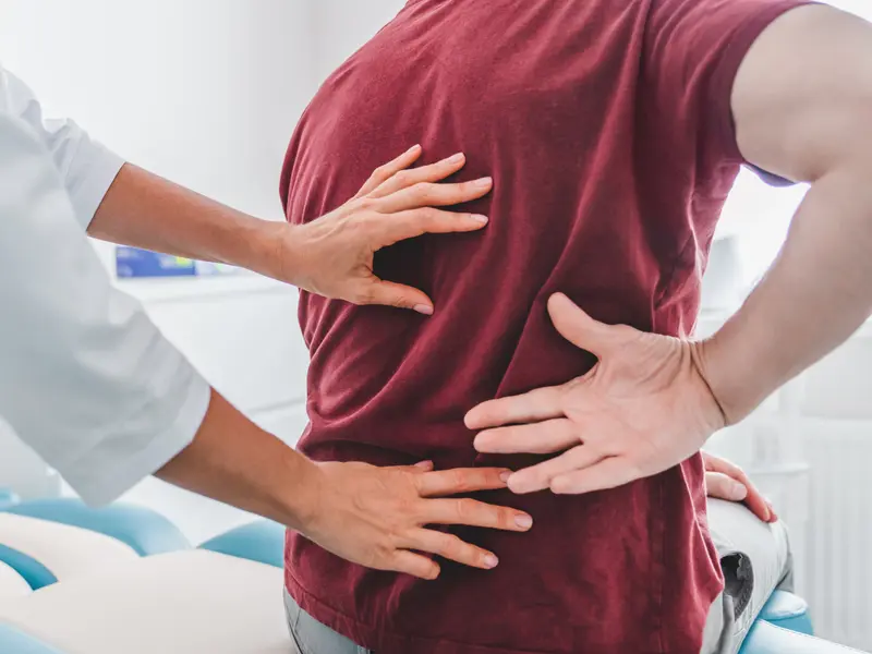 Orthopedist examining patient's back