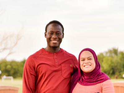 Yazmin, a patient at Baylor Scott & White Health, and her husband standing smiling outside.