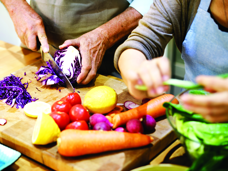 couple cooking a meal with their own hands after receiving hand and wrist care