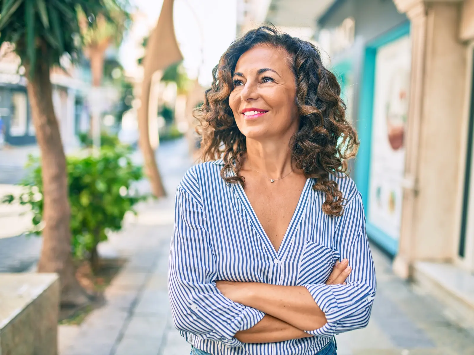 A woman stands outside while experiencing the signs of perimenopause 