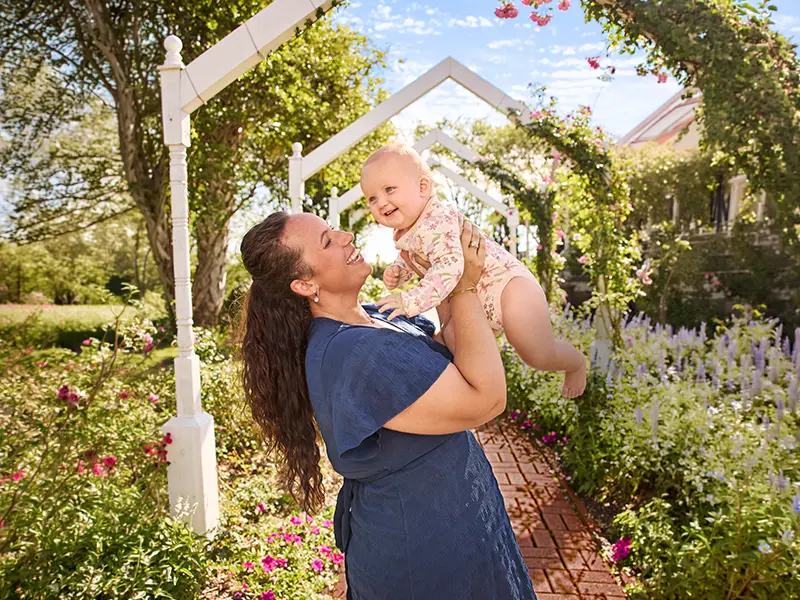 Mother hoisting her baby