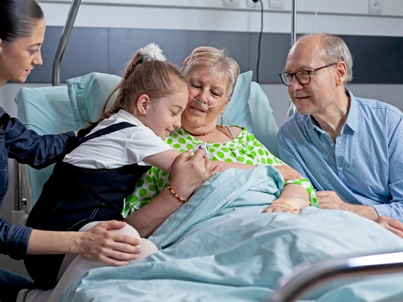 Woman in palliative care with visiting family