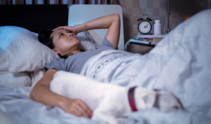 A woman lies awake unable to sleep