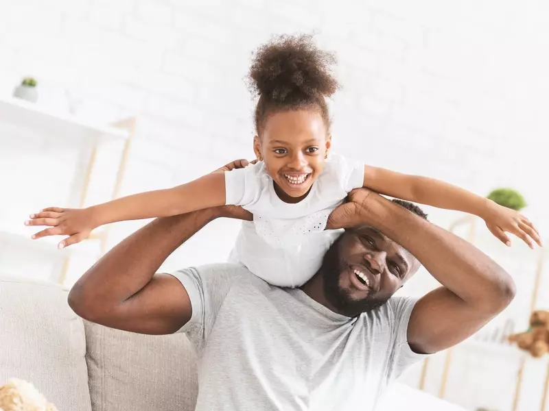 a father playing with his daughter