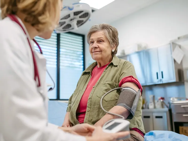 Senior woman having blood pressure checked, preventive care