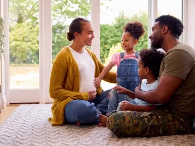 A happy pregnant woman with her family, confident in her birth plan ahead of her labor and delivery