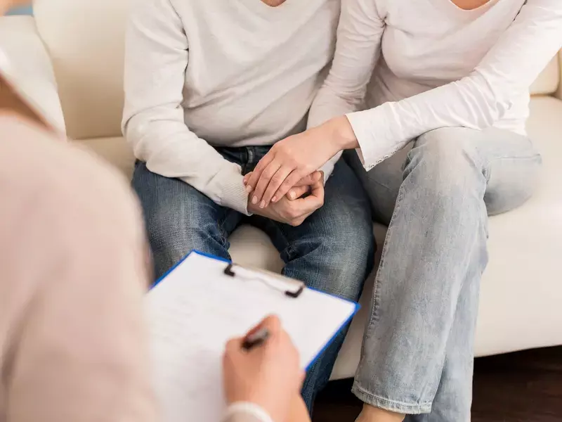 couple sitting in doctor office discussing colorectal cancer risk factors with medical professional