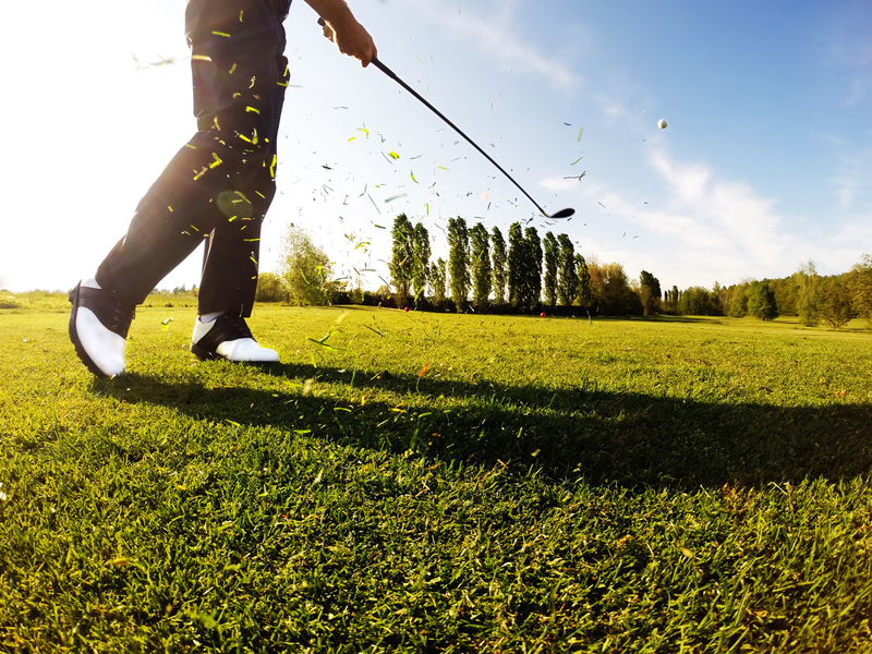 man playing gold after receiving treatment for his bursitis