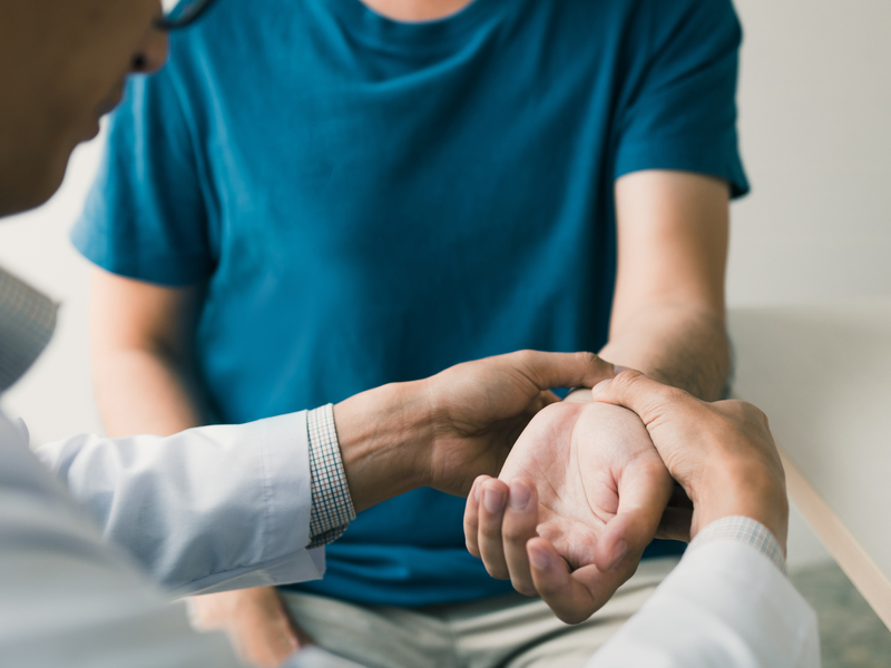doctor examining a patients wrist for any pain or issues