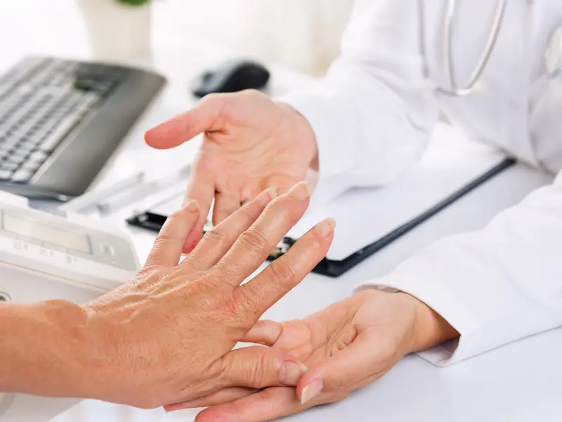 doctor examining patients hand and wrist