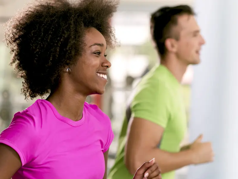 man and woman running on treadmill for orthopedic physical therapy