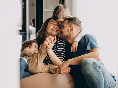Happy parents spending time with their children, one of the most important things for family wellness.
