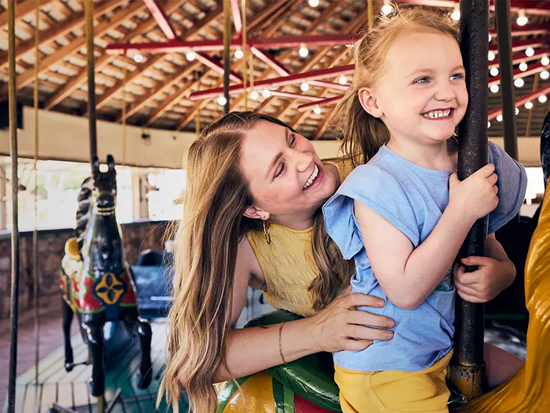 Woman and child on carousel