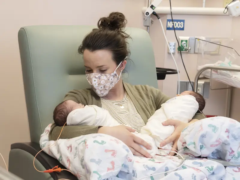 New mom Lindsey Bass holding her babies in the NICU