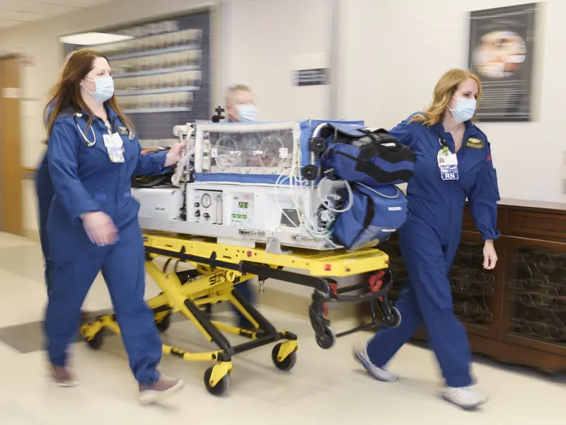 Maternal transport team moving a baby